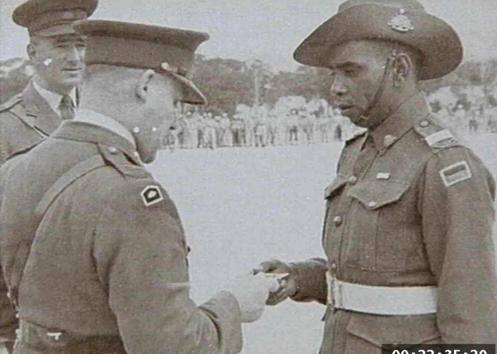 Reg Saunders receiving a decoration in Korea